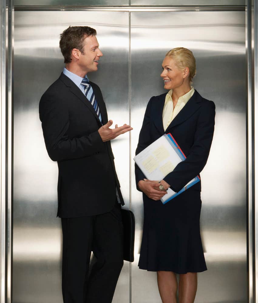 Two colleagues talking in an elevator making eye contact