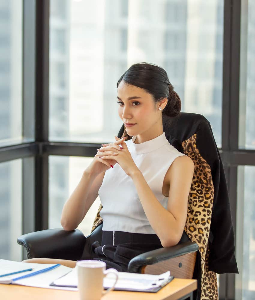 Professional woman sitting with a commanding posture