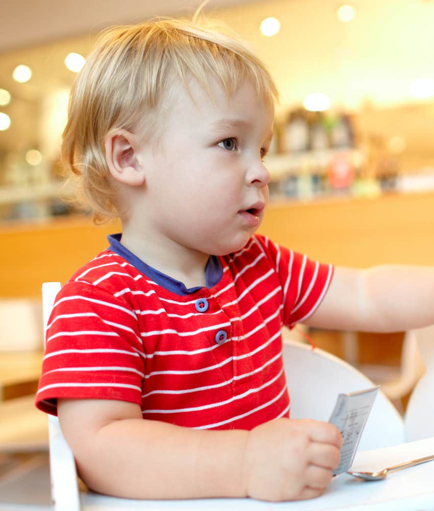 little boy sitting in restaurant