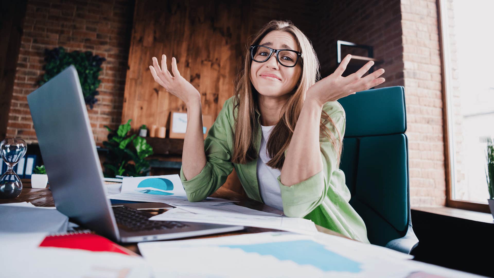 woman shrugging while working 