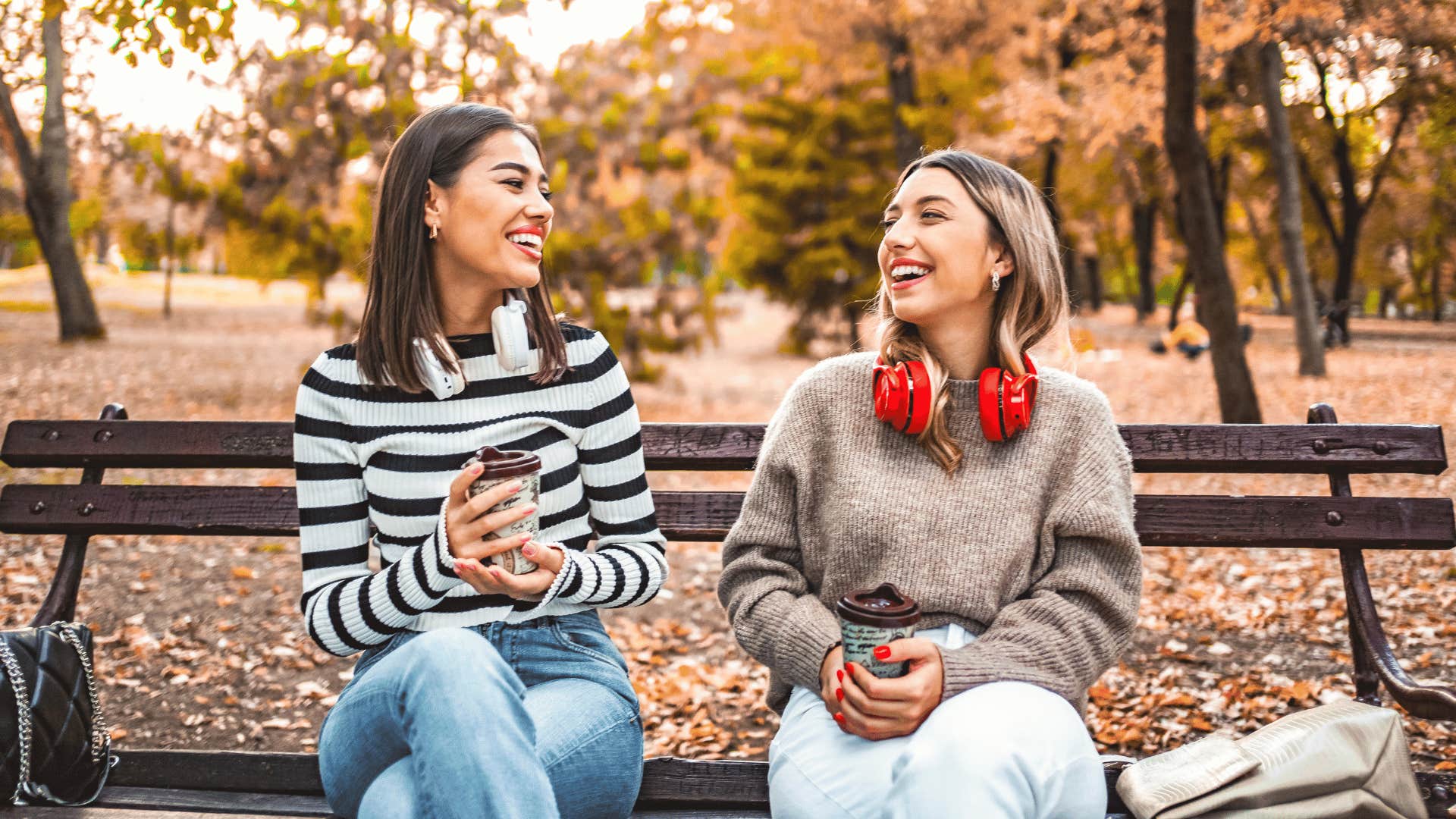 two woman chatting on bench