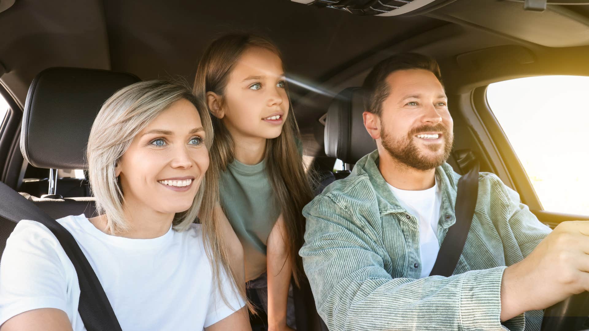 Family smiling and laughing together in the car