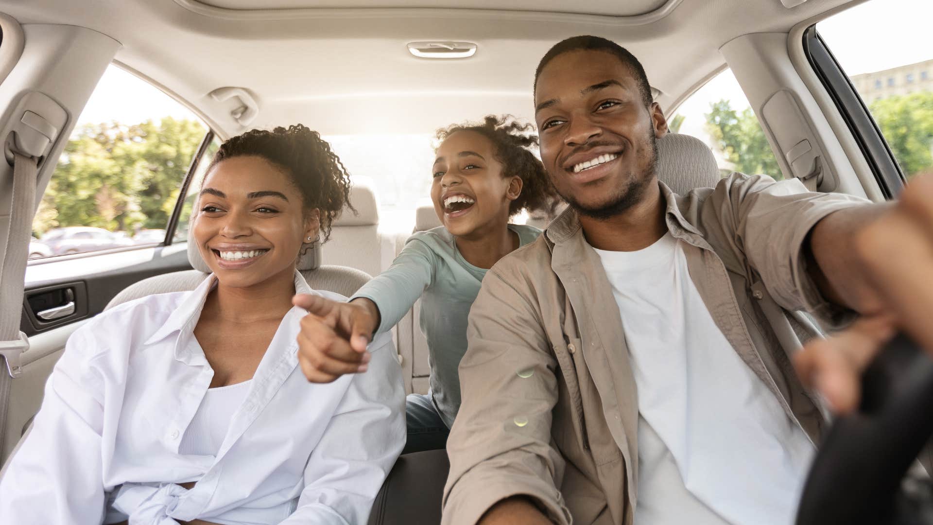 Family smiling in their car