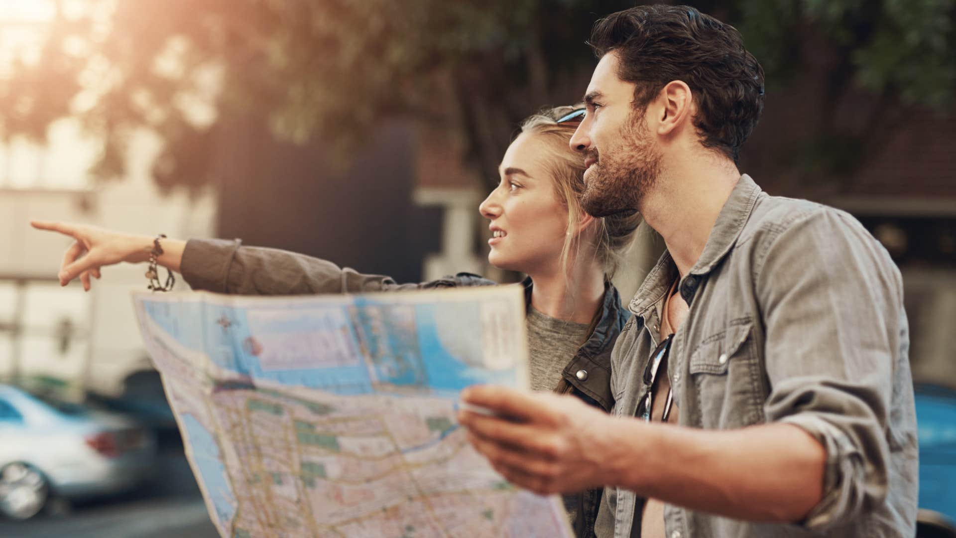 Couple smiling while using a paper map