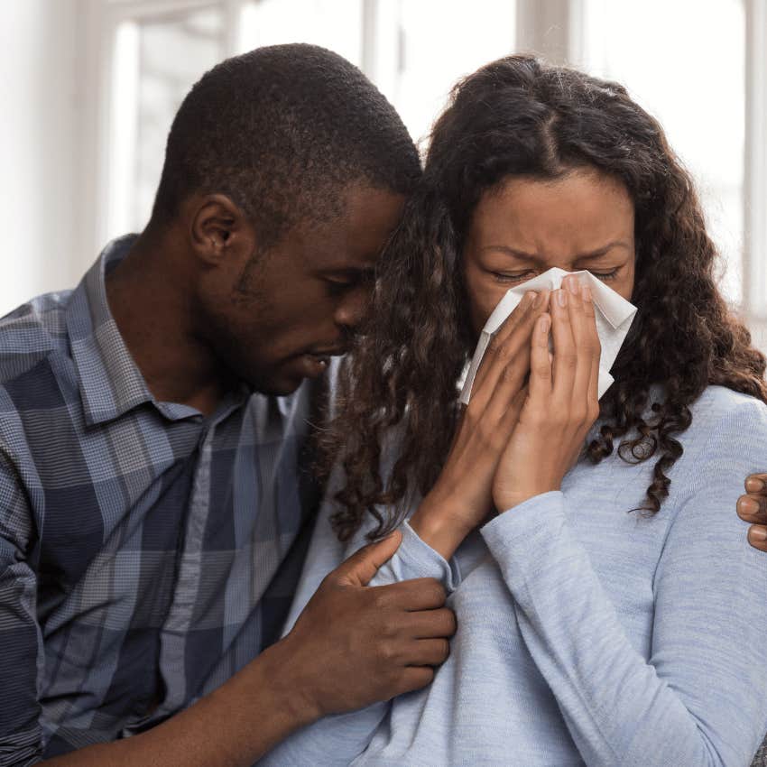 man comforting an upset woman