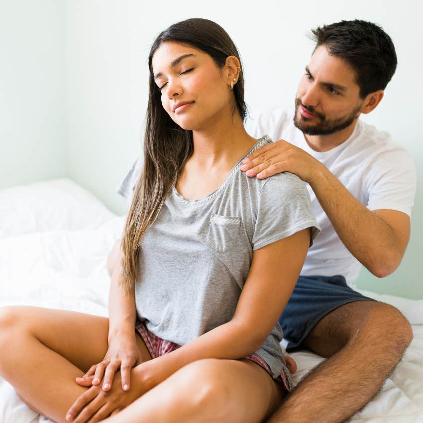 Man in a happy couple giving his partner a massage