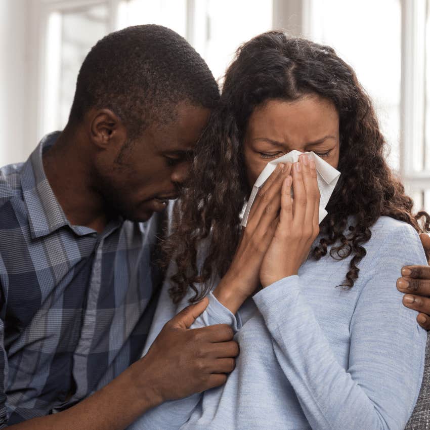 man hugging and comforting an upset woman