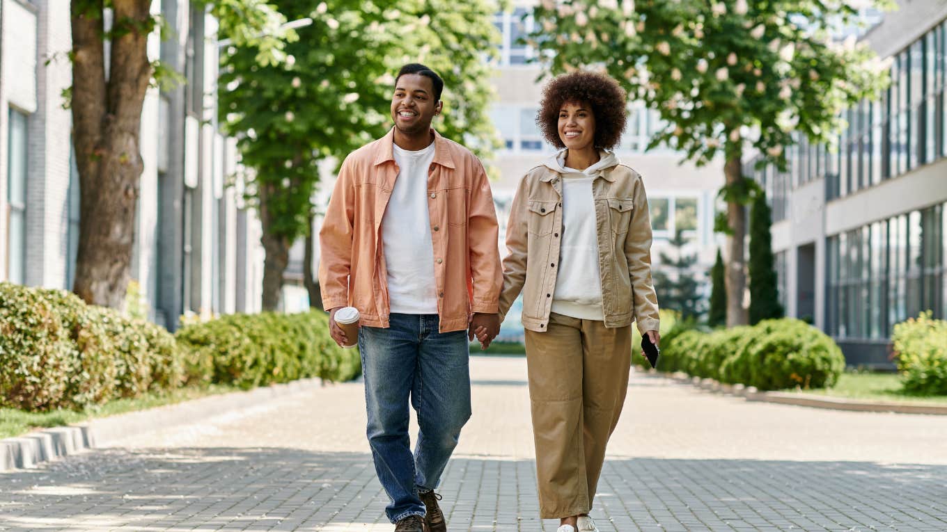 Couple walking on sidewalk holding hands