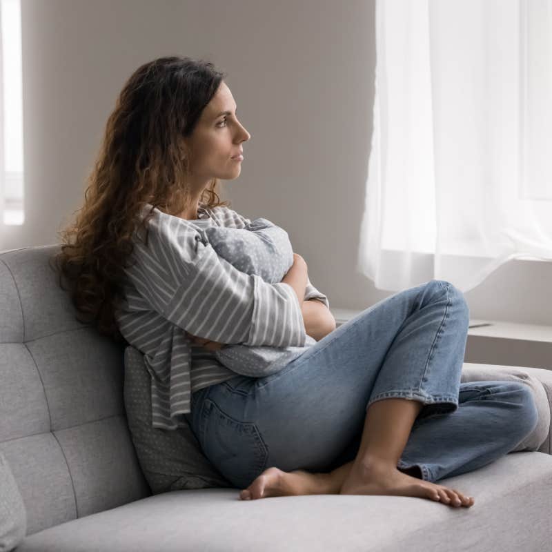 serious woman sitting on couch 