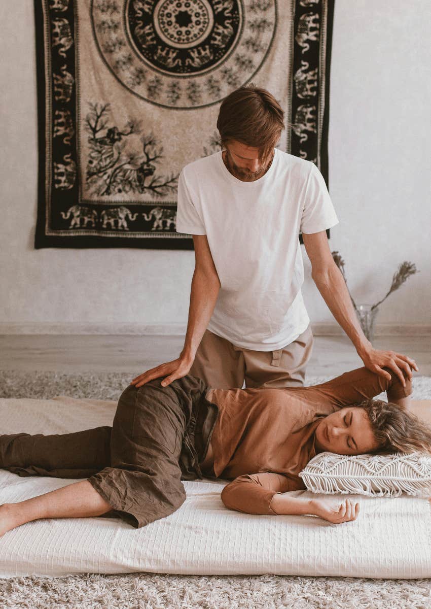 man massaging woman on a floor