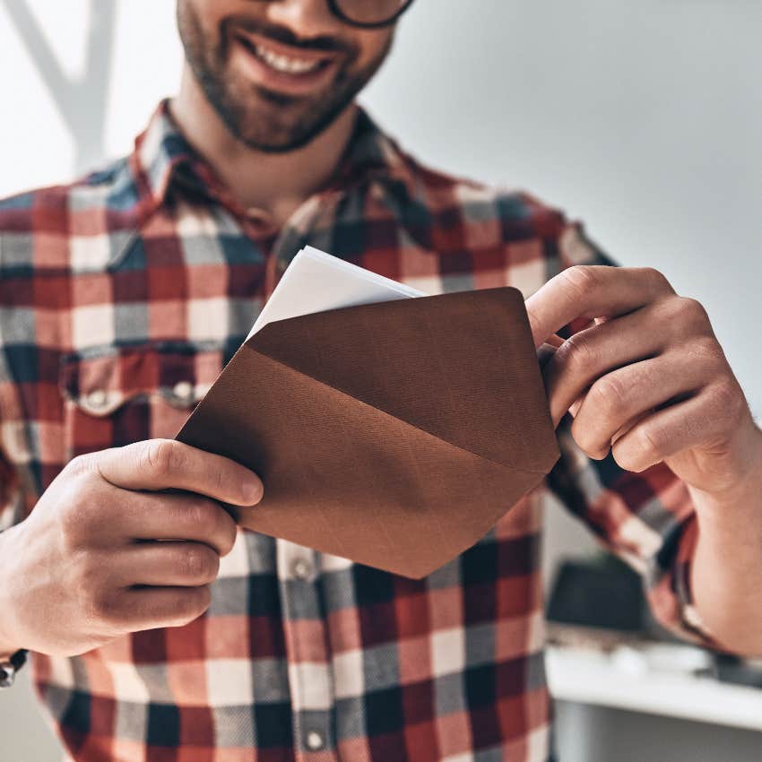 Man opening wedding invite