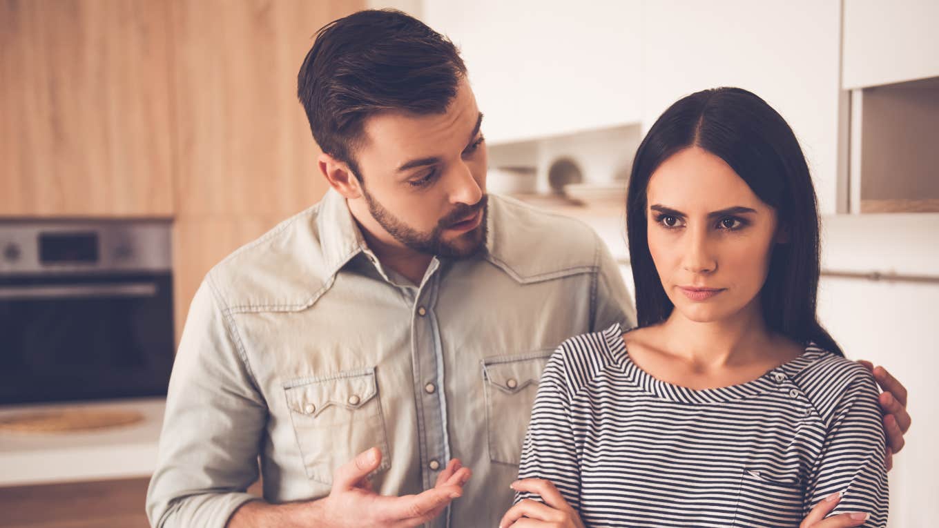 Couple breaking up in their kitchen over a messy silverware drawer