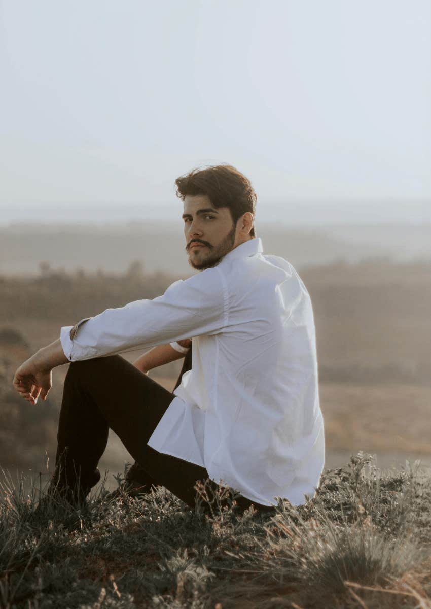 man sitting on a hilltop