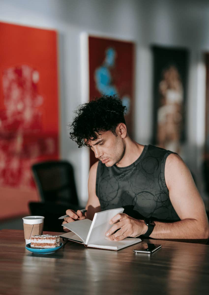 man sitting at a table journaling