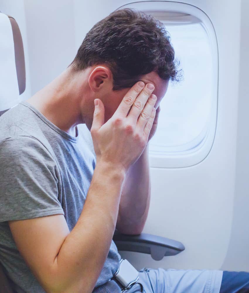 man uncomfortably sitting on flight after getting burned by hot tea