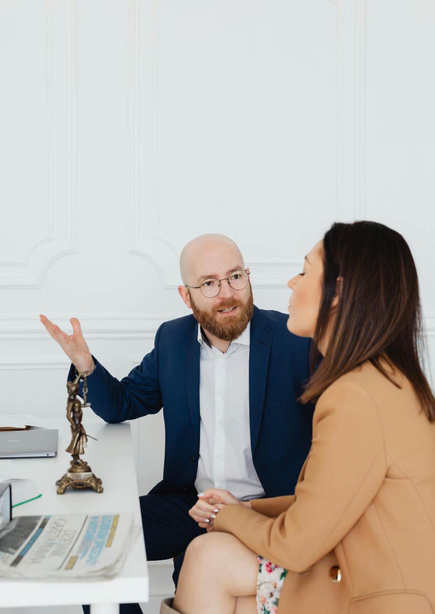 man yelling at woman while sitting at a desk