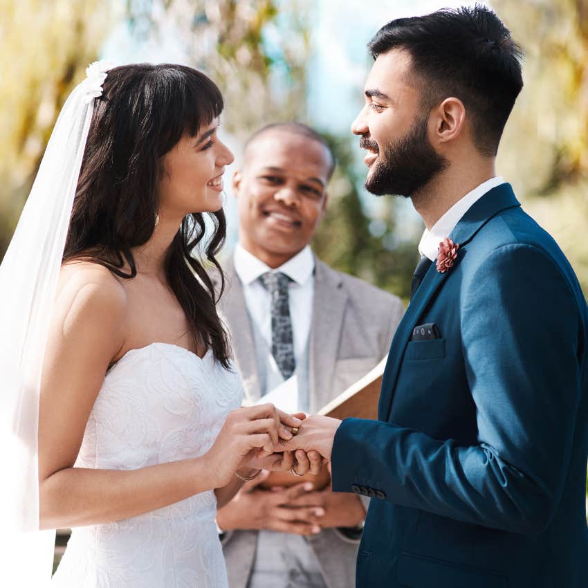 Happy couple, wedding and holding hands with priest for vows