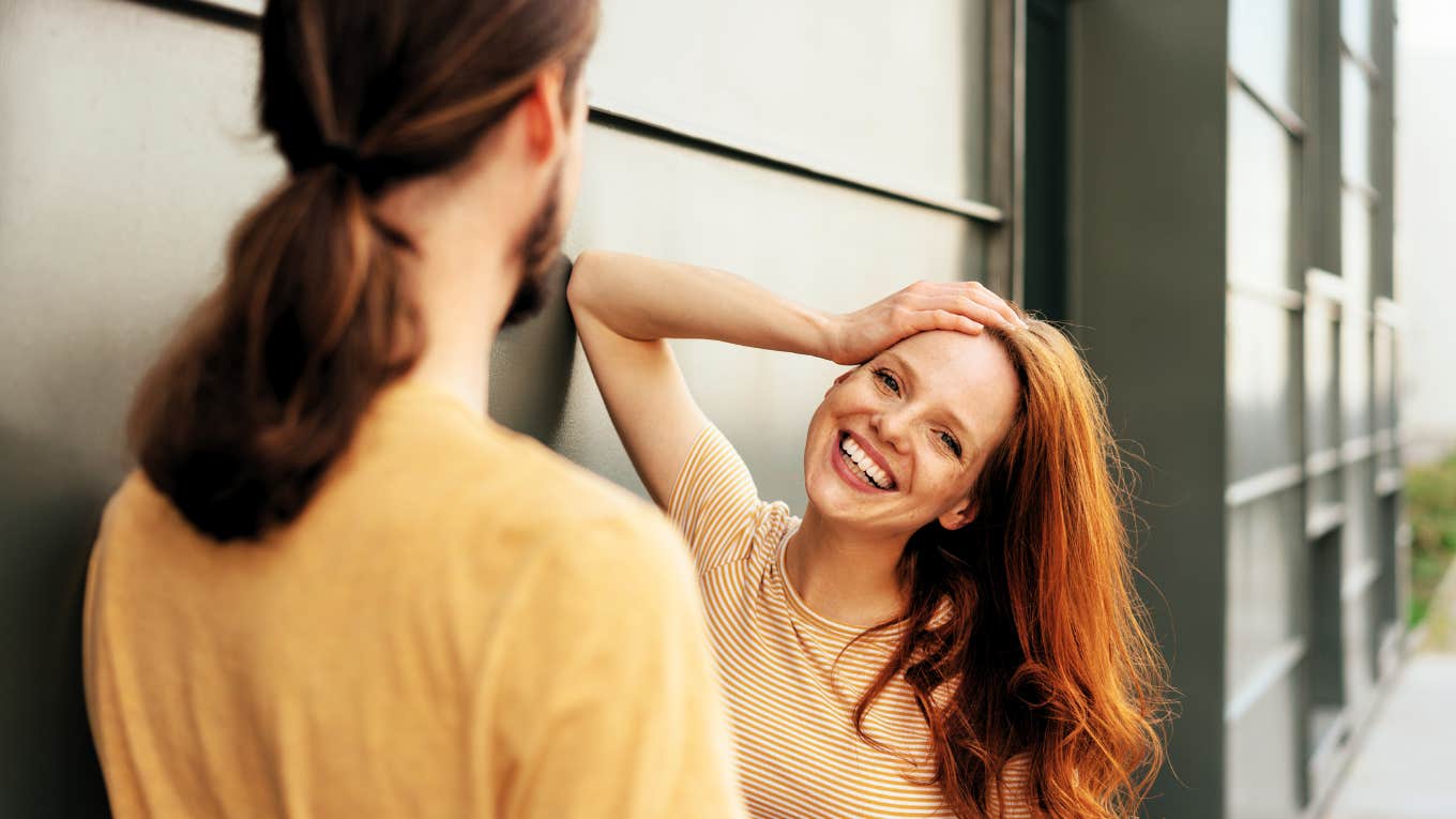 Woman using flirty body language to speak to man