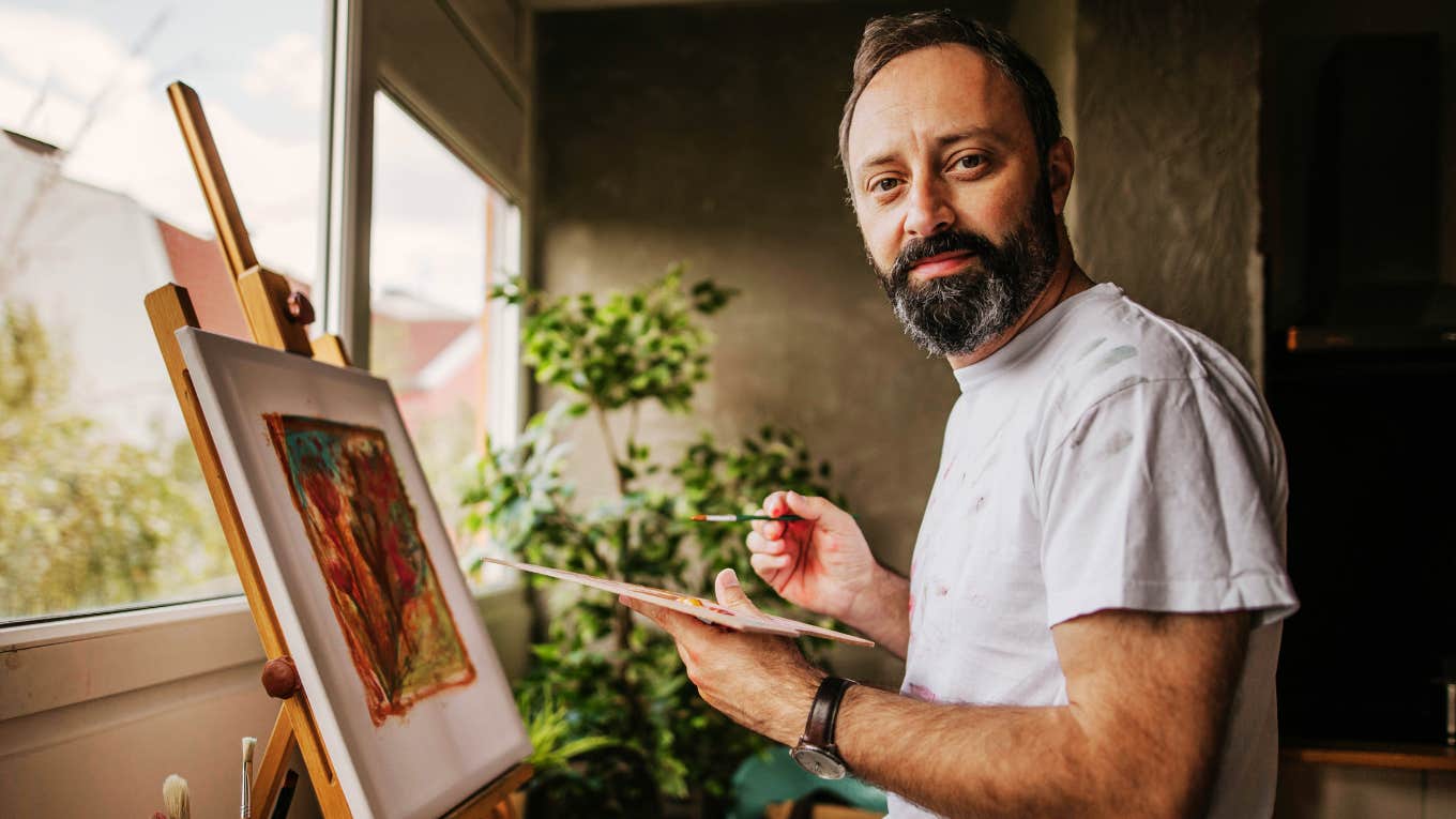 Man mastering the skill of painting. 