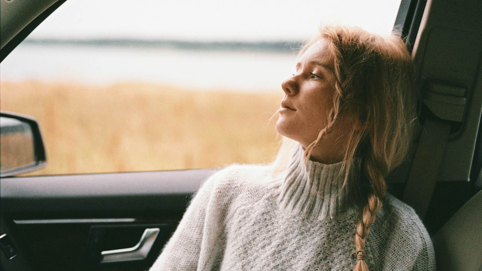 woman looking out car window