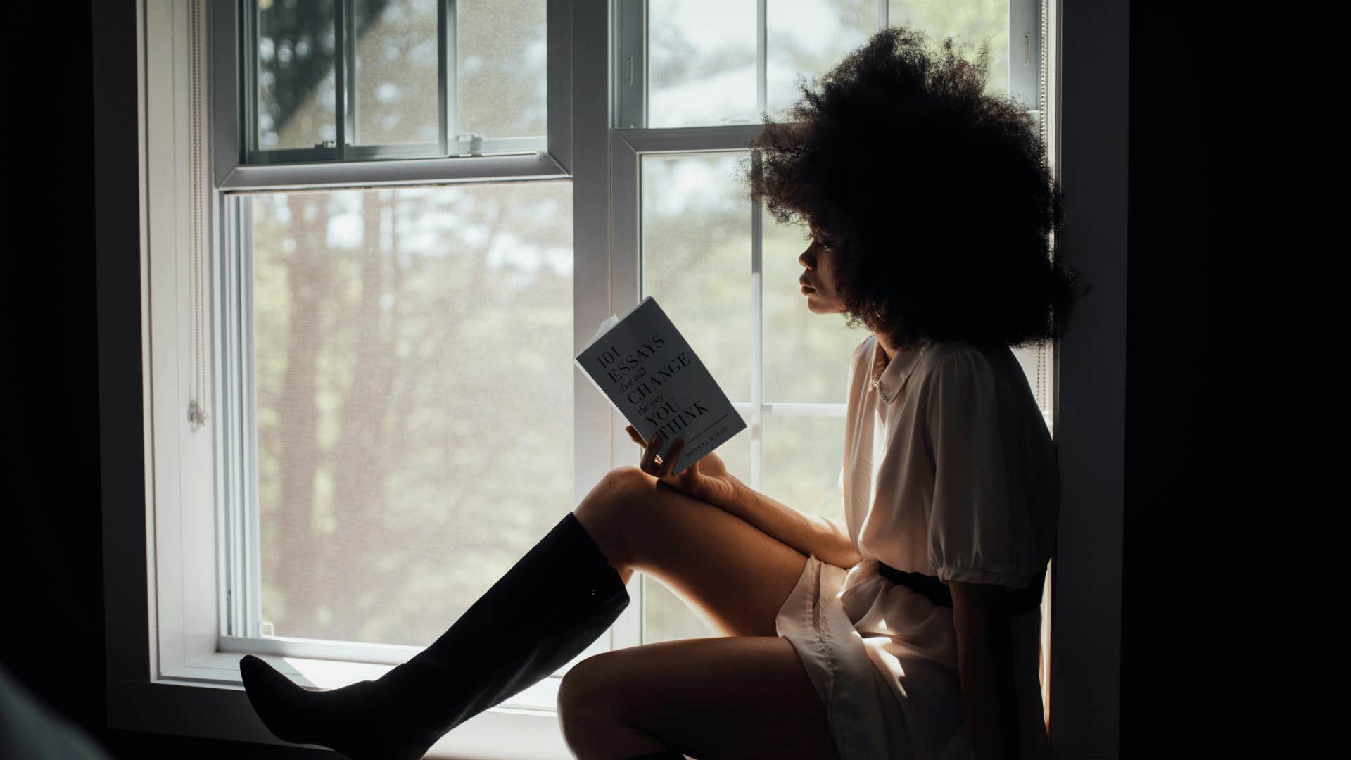 woman sitting alone reading