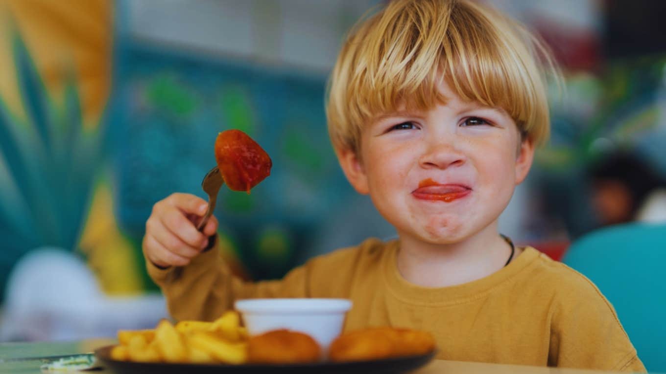 little boy eating at restaurant 