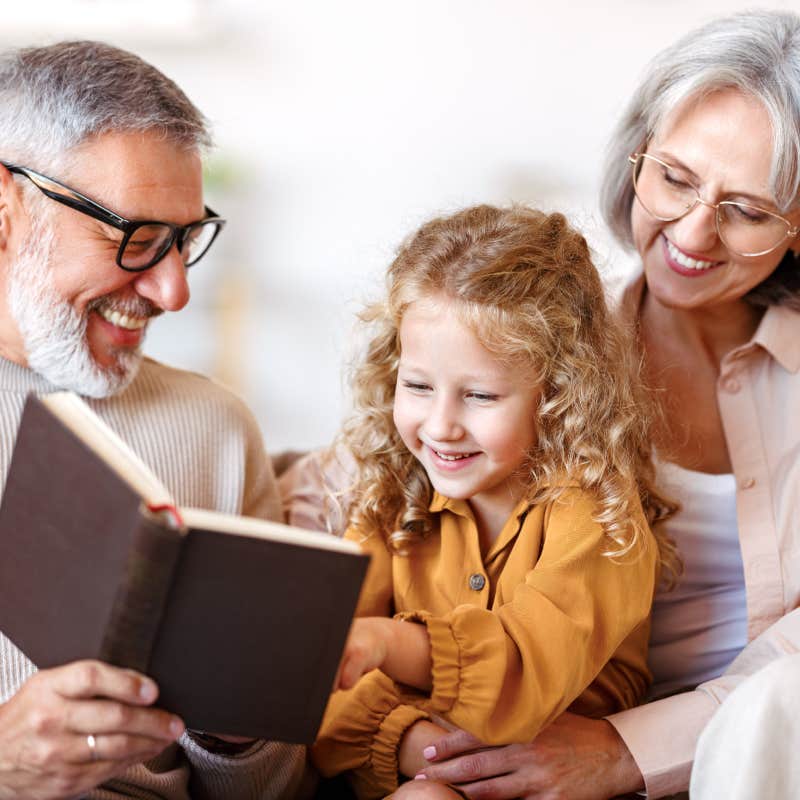 grandparents reading to granddaughter