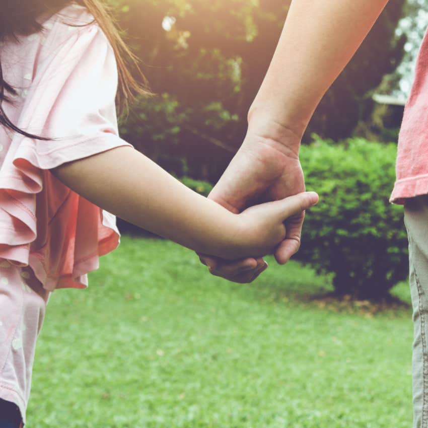 mom holding daughter's hand 