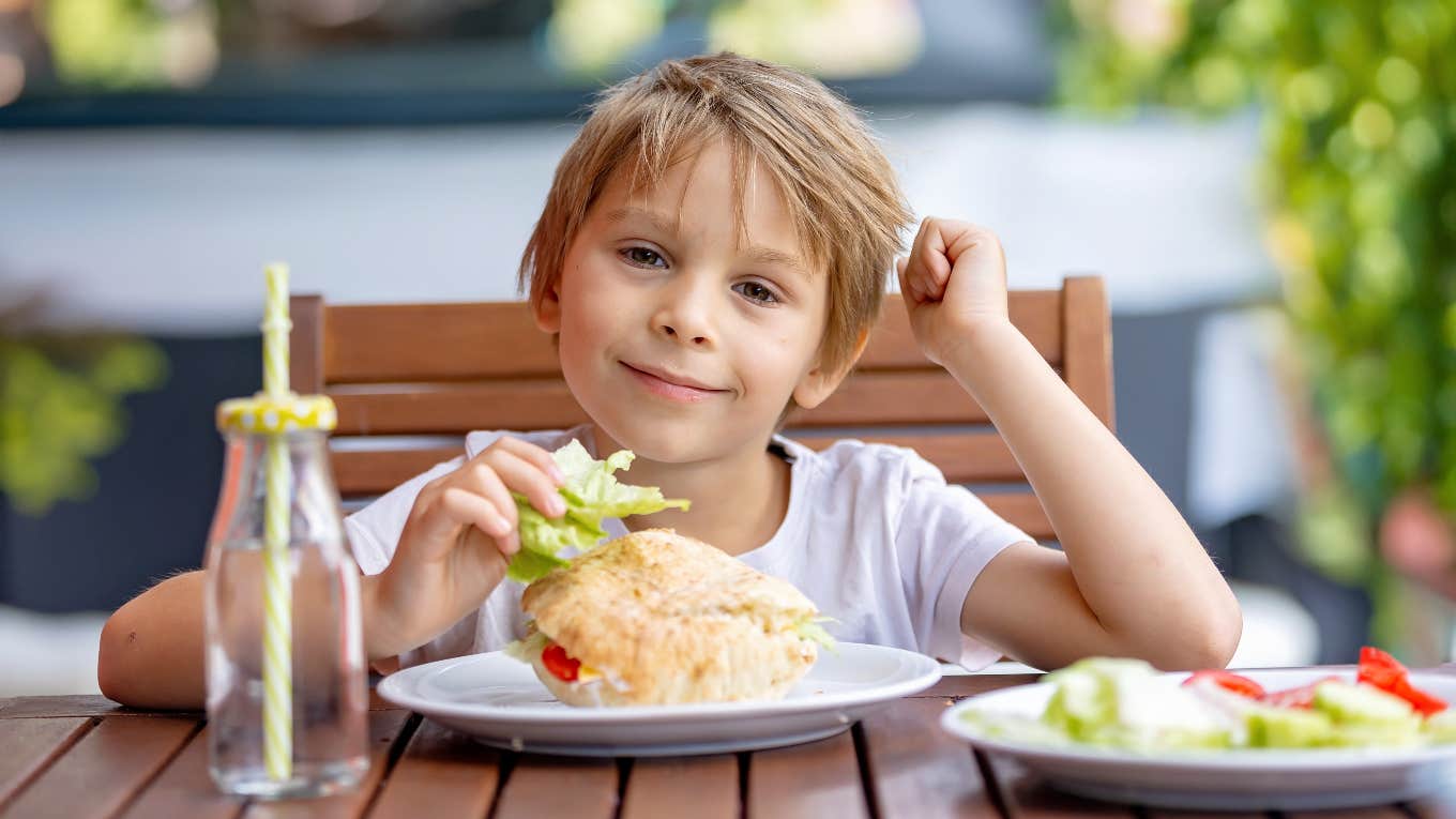 Kid eating at a brewery