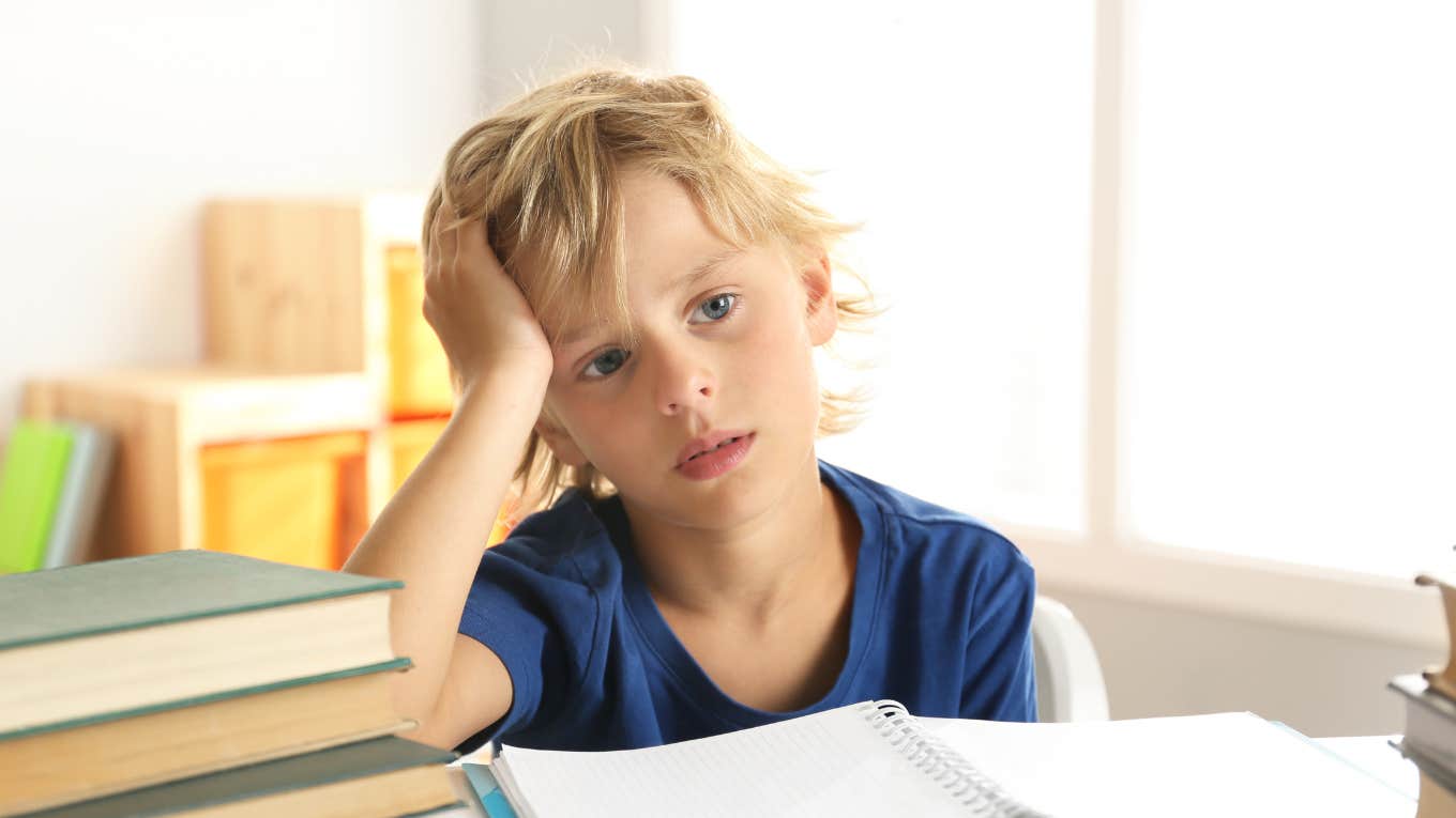 First-grade boy struggling with homework