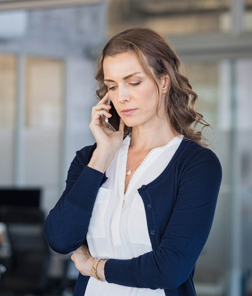 woman talking on a cell phone with a serious expression