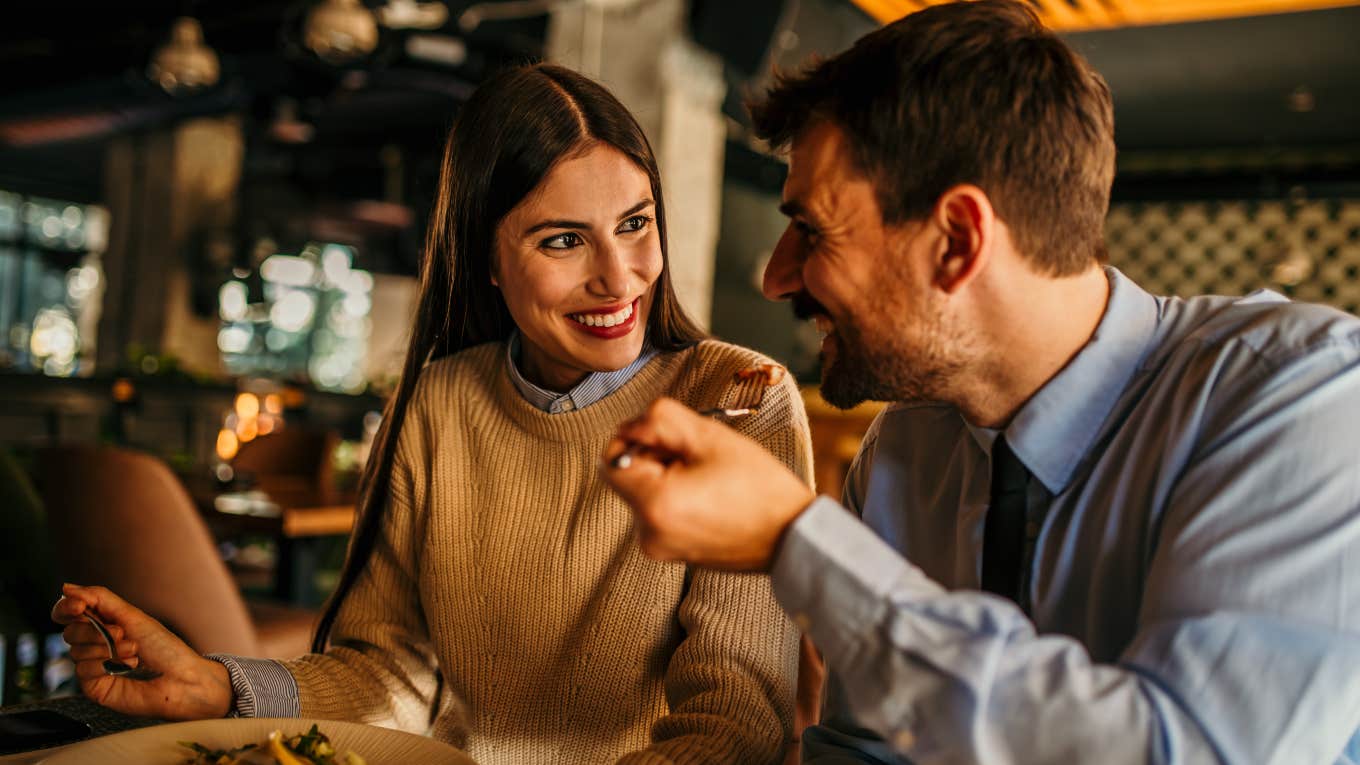 man and woman on a date eating together