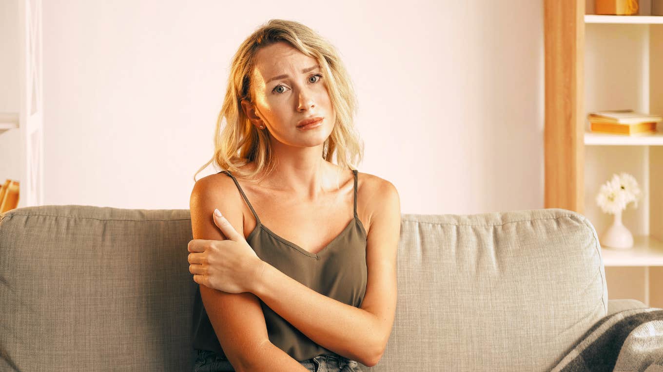 Woman feeling sad and lost with no connection, sitting in therapists office