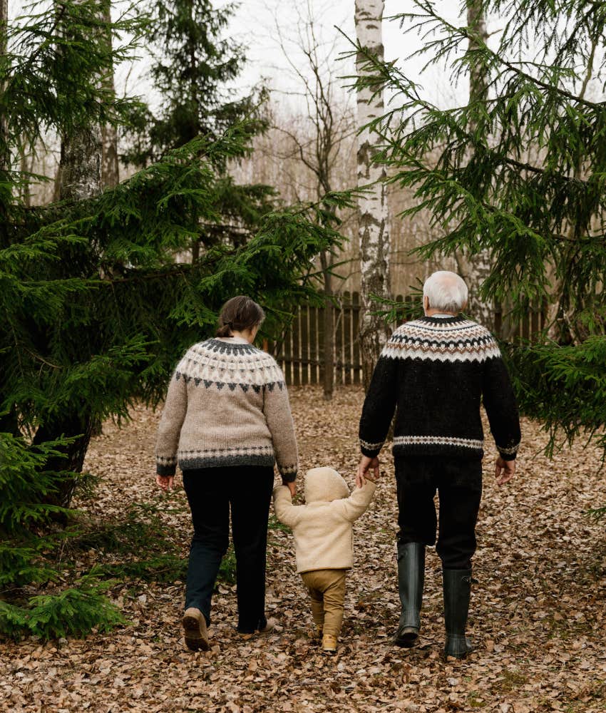 Grandparents taking a walk in the woods with grandchild