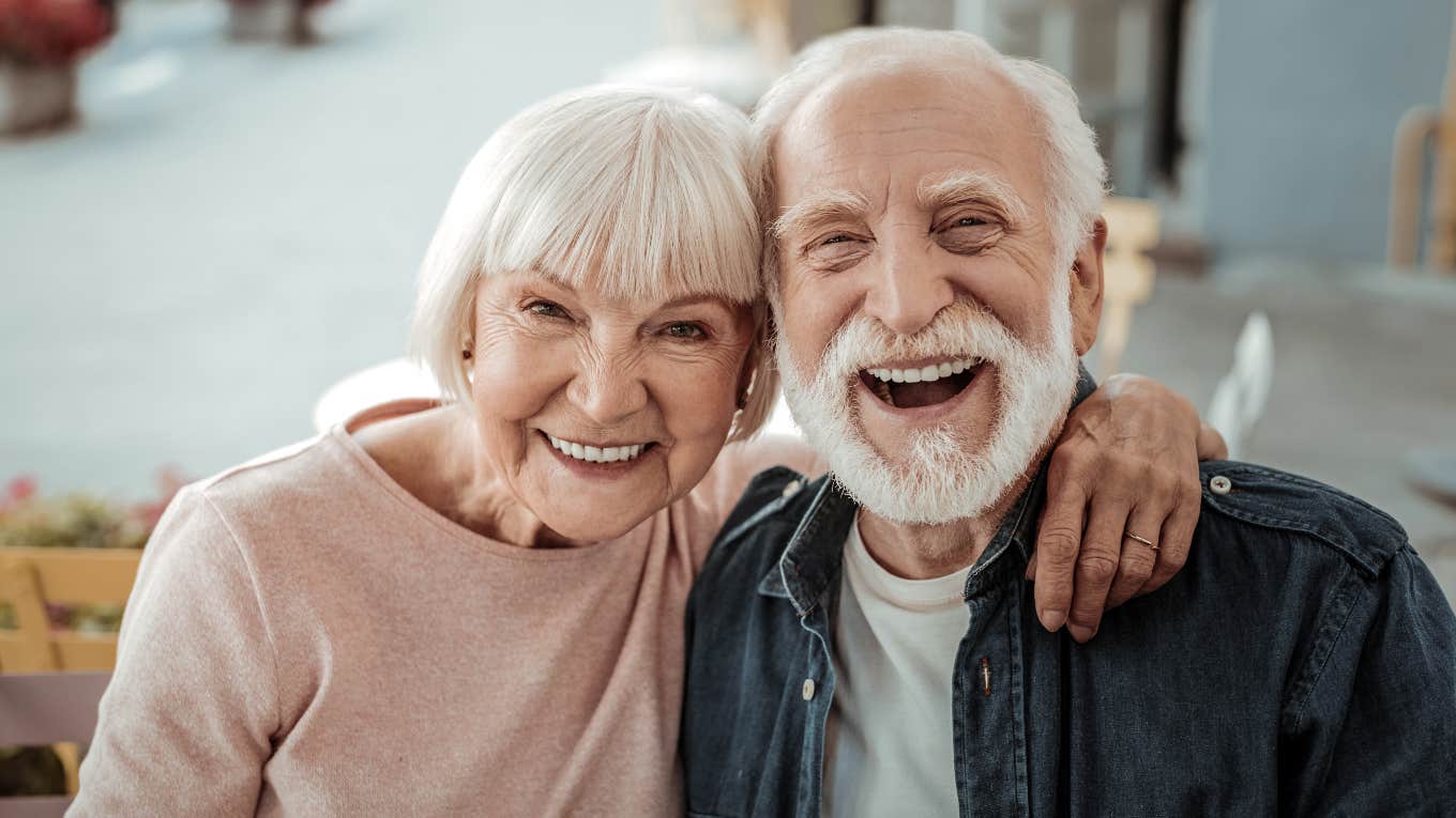 elderly couple smiling at the camera