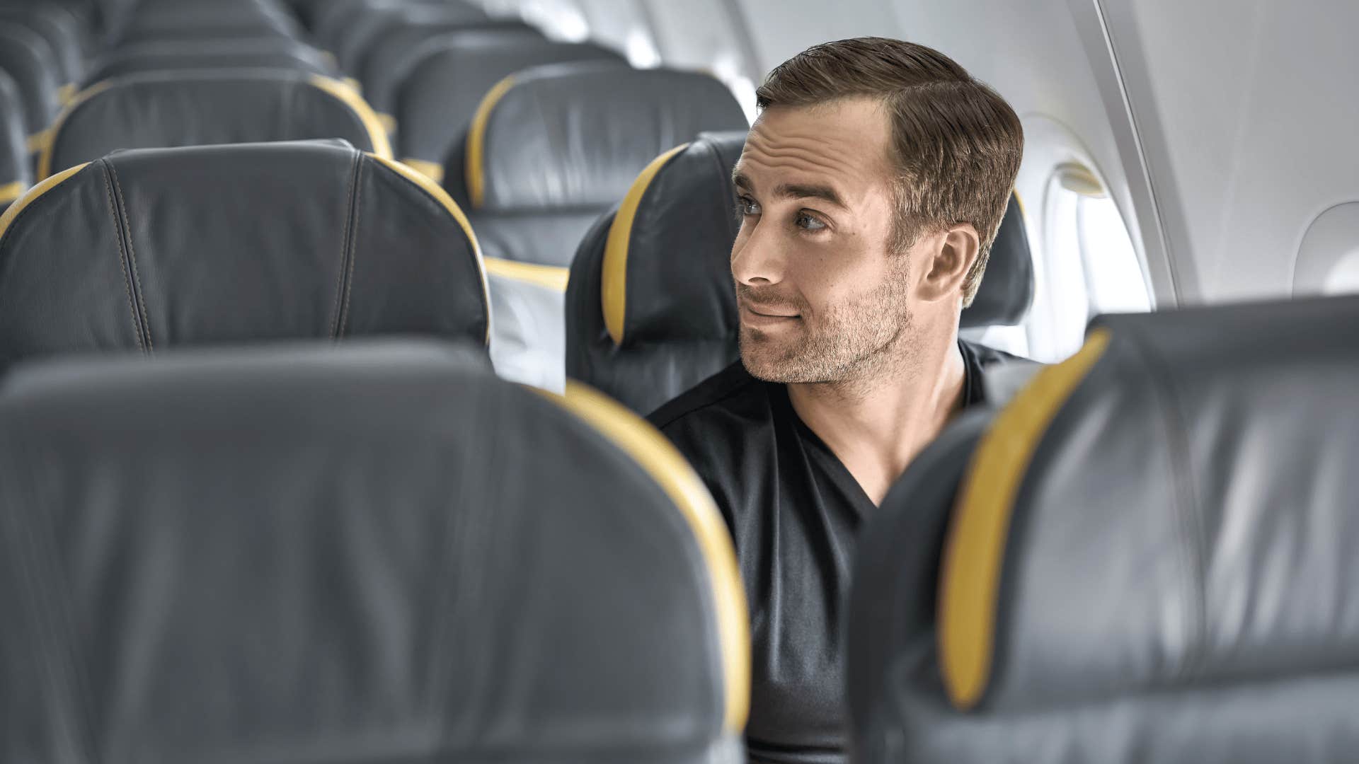 man sitting on airplane seat