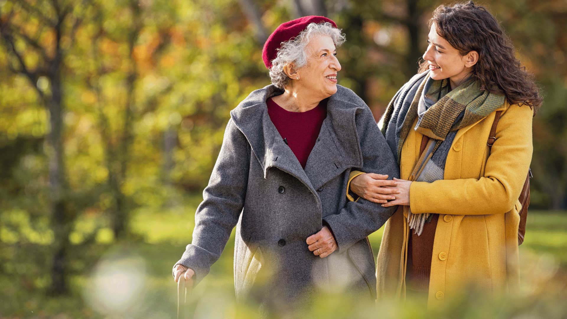 younger woman walking with older woman 