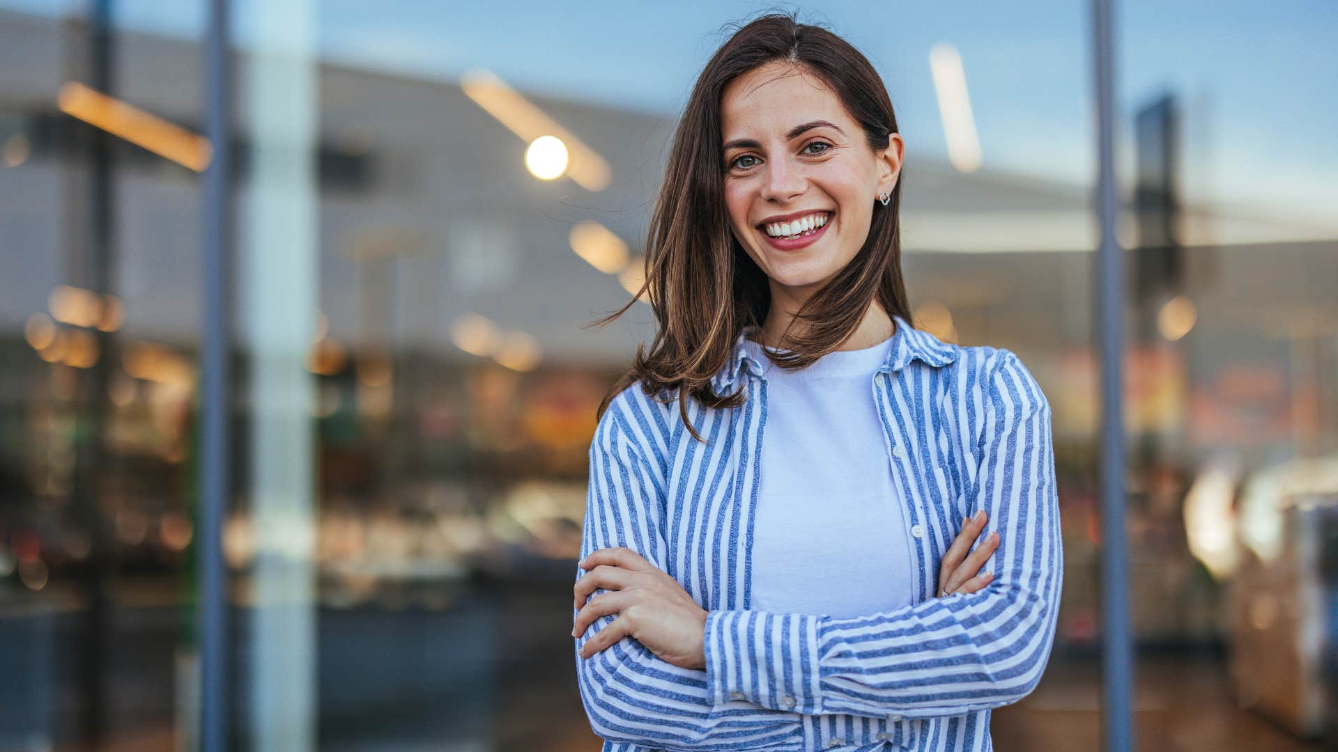 Woman smiling in a button down shirt.