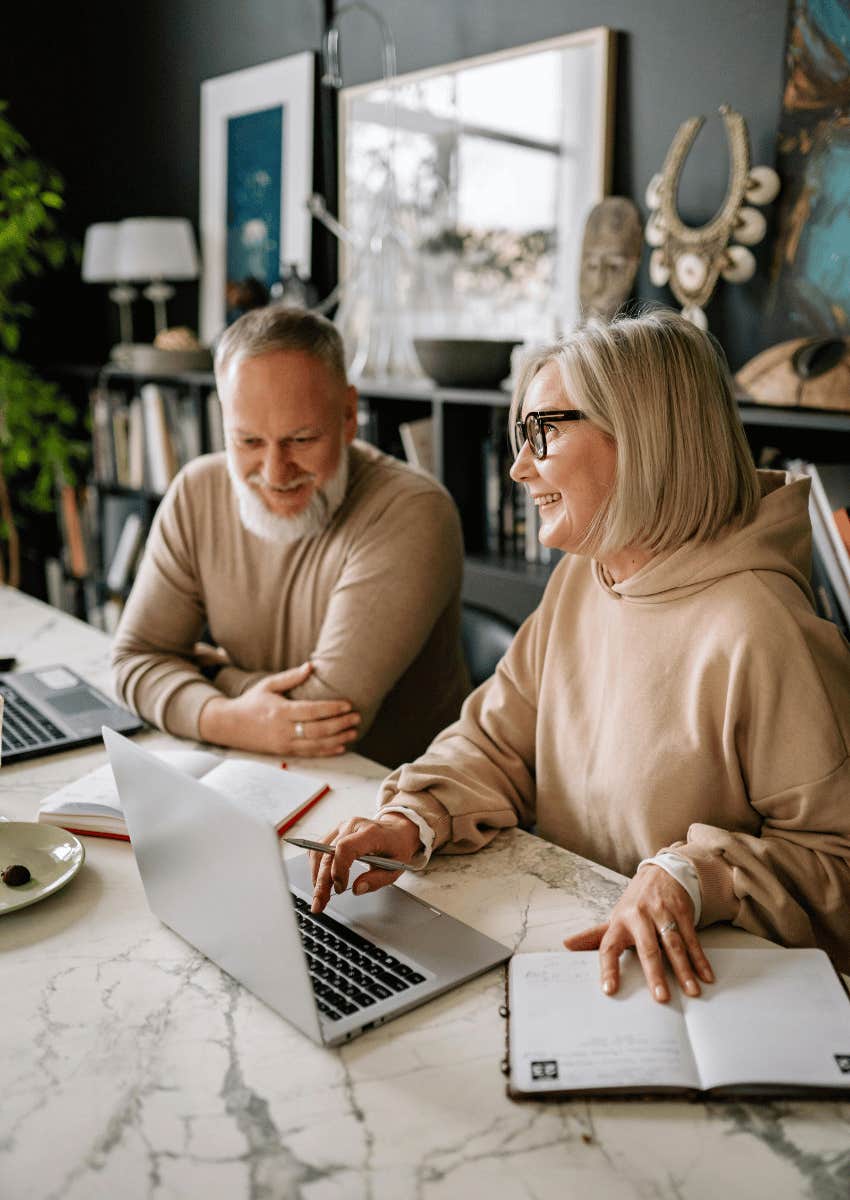 older couple working on laptops together