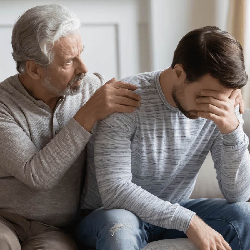 older man helping upset younger man