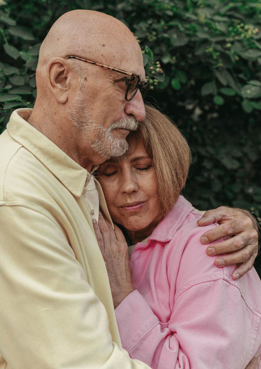 older man hugging older woman close