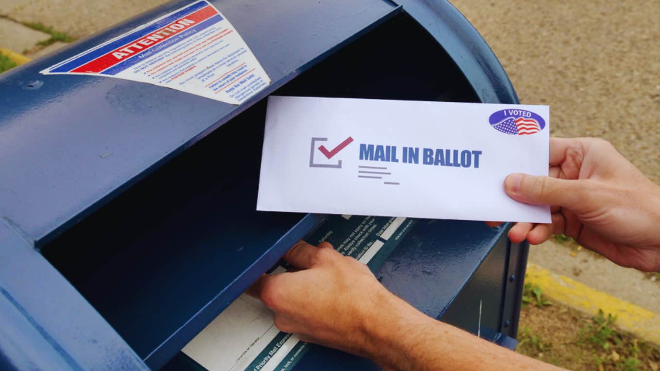 man casting mail-in vote 