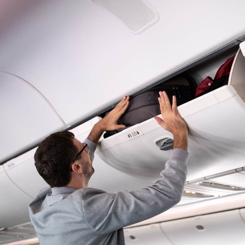 Man putting bag in filthy overhead bin on plane