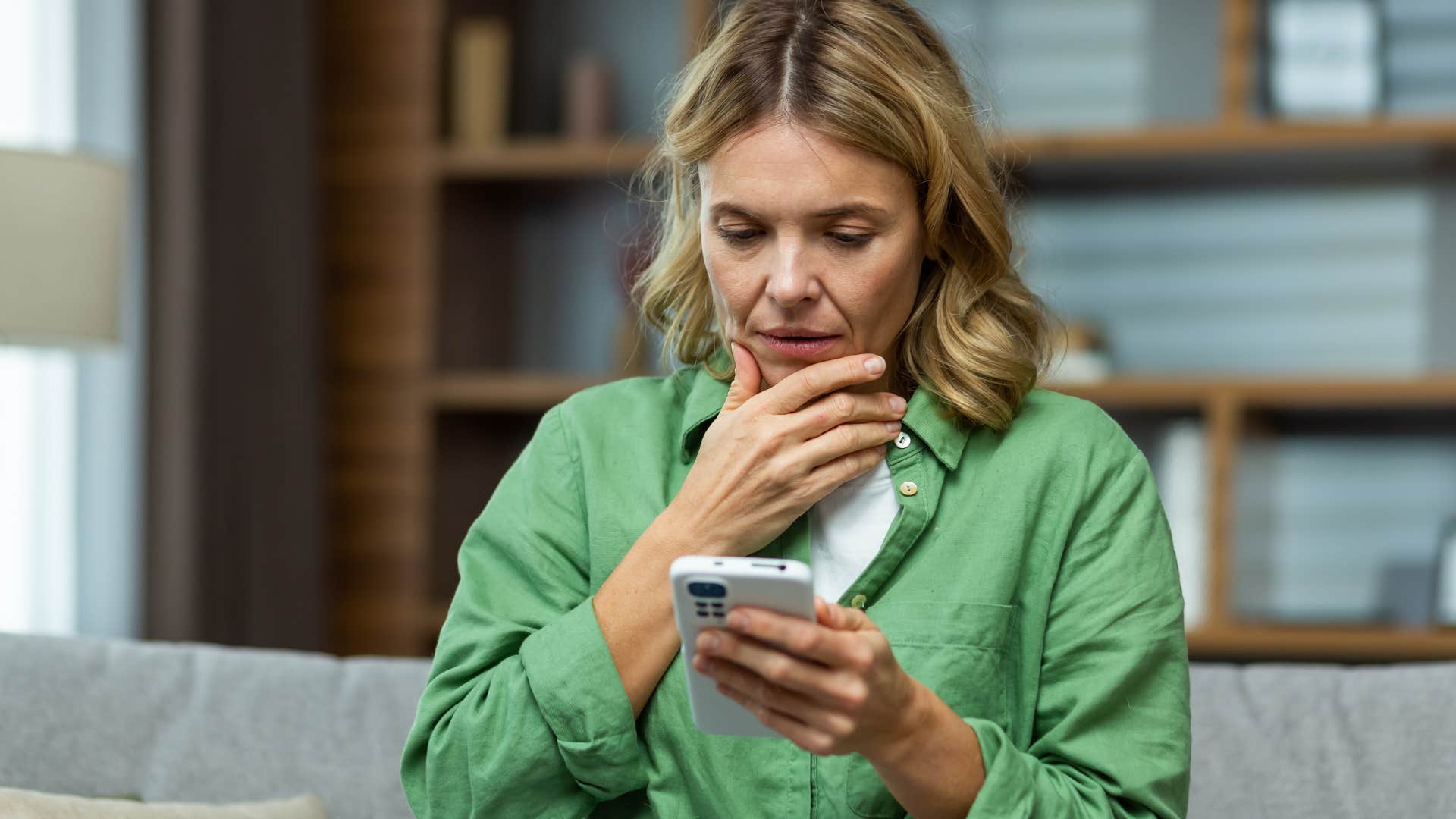 Shocked woman staring at her phone.