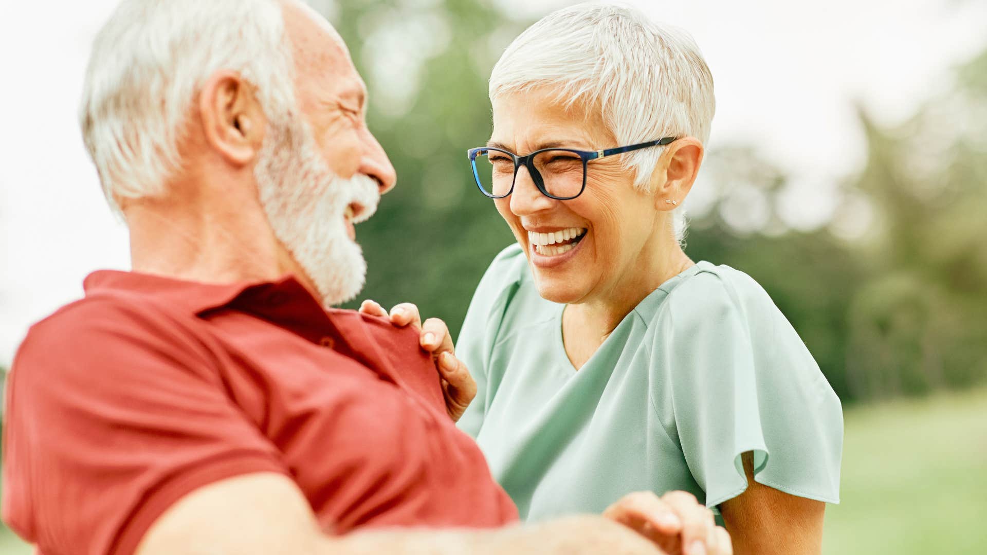 Older couple smiling at each other.