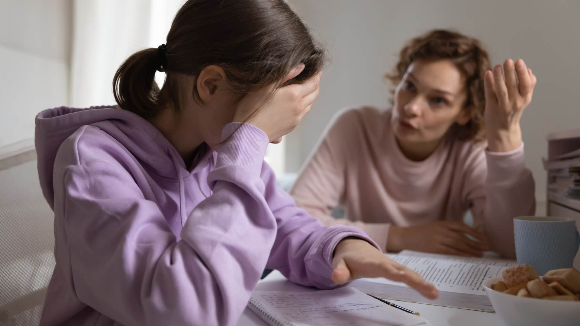 Woman talking to her annoyed teenage daughter.