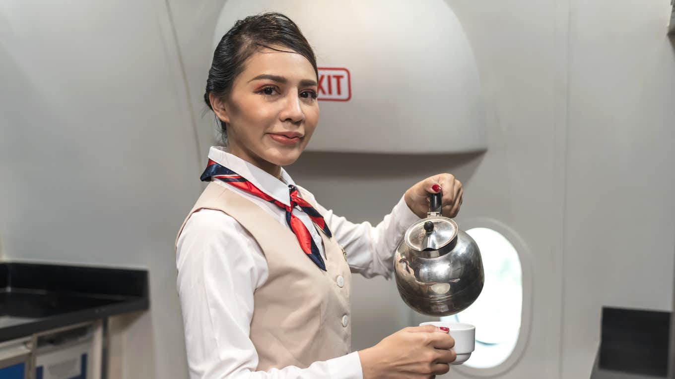 Flight attendant preparing hot cup of tea for passenger