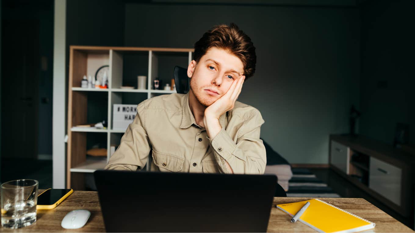 Person feeling miserable in their head at desk. 