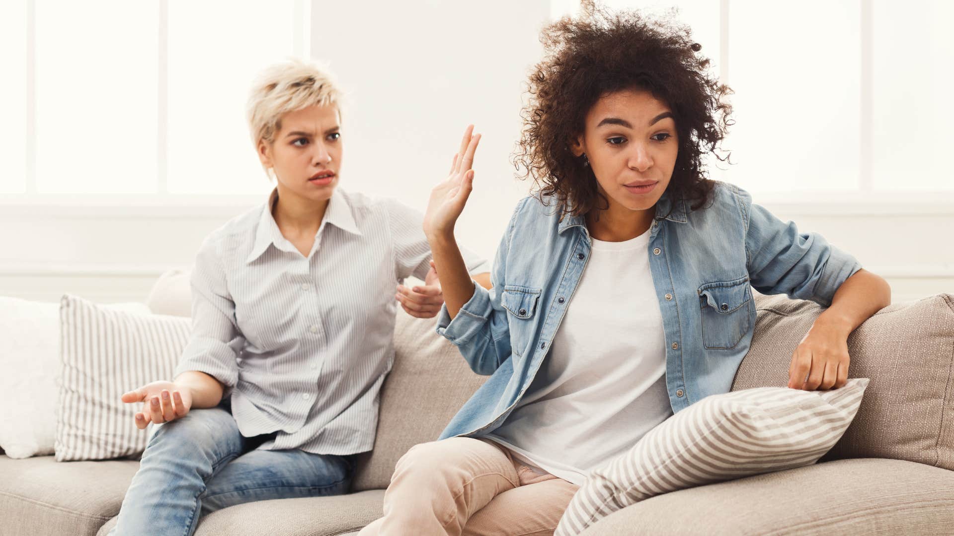 Woman looking upset while her friend argues with her.