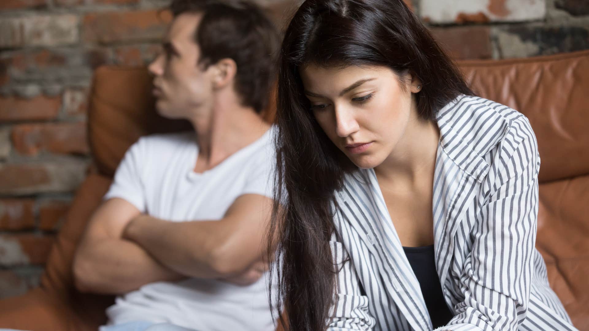 Woman looking sad away from her partner.